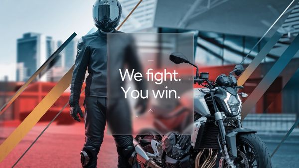 motorcycle-rider-standing-next-to-motorcycle-you-fight-we-win-Road-Warrior-Law